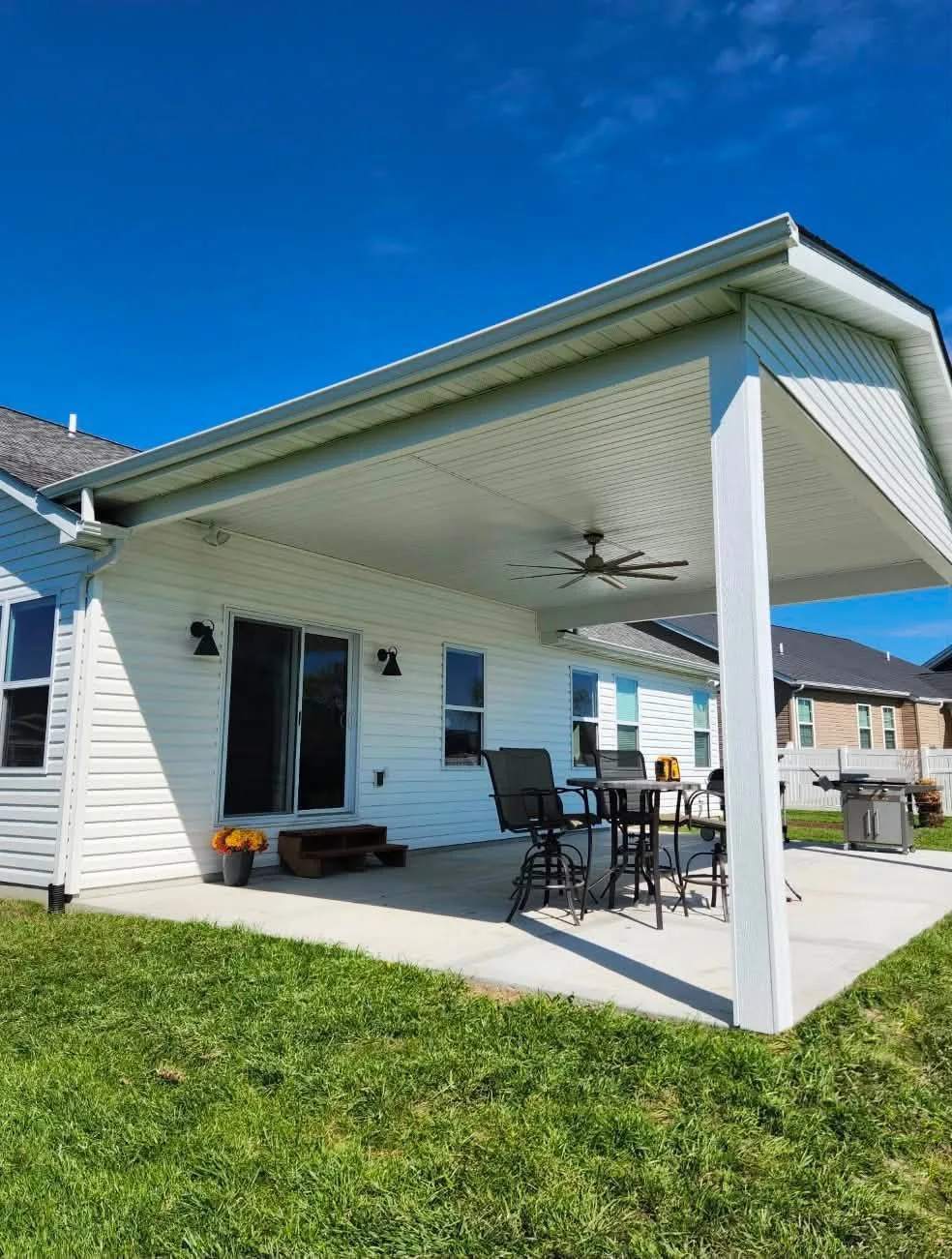 White gabled covered patio over a concrete slab