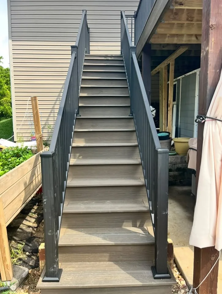 Long finished gray deck stair run with dark railings