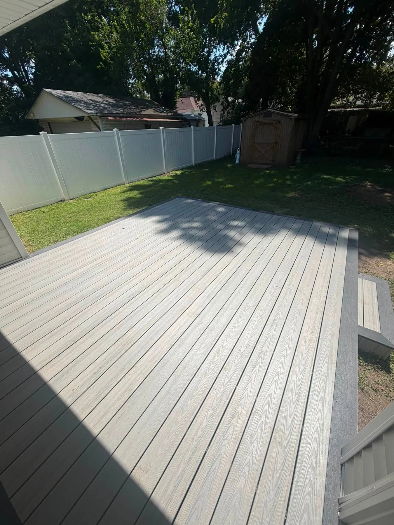 Low-profile gray deck viewed from the yard