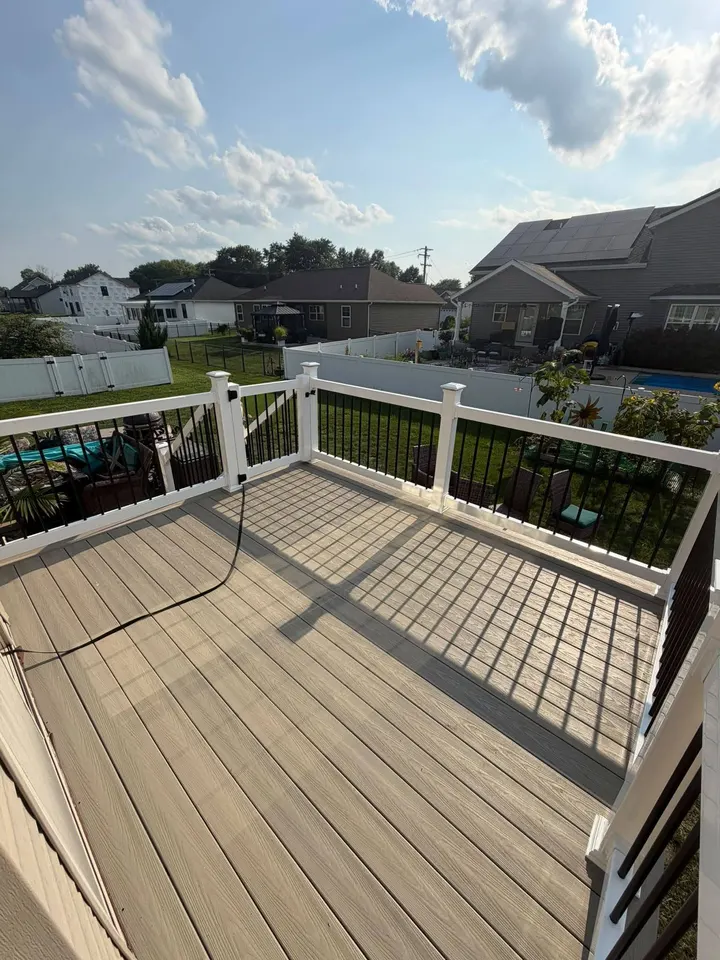 Finished gray deck with white posts and dark balusters