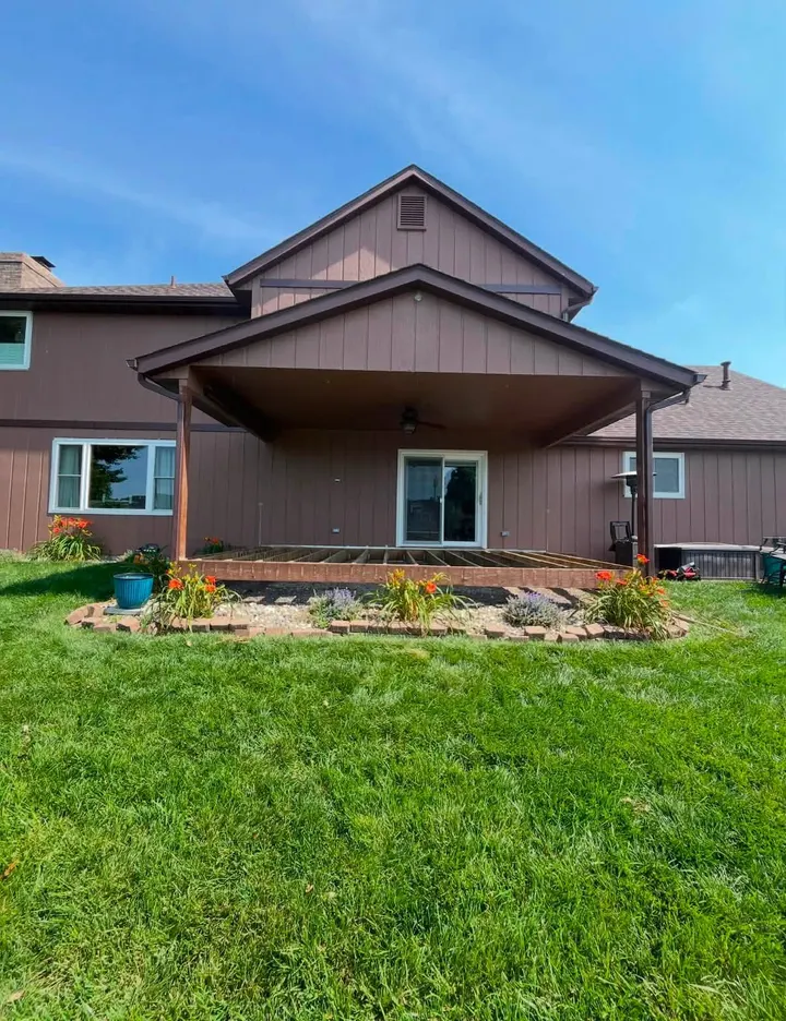 Completed brown home exterior with refreshed siding, trim, and porch