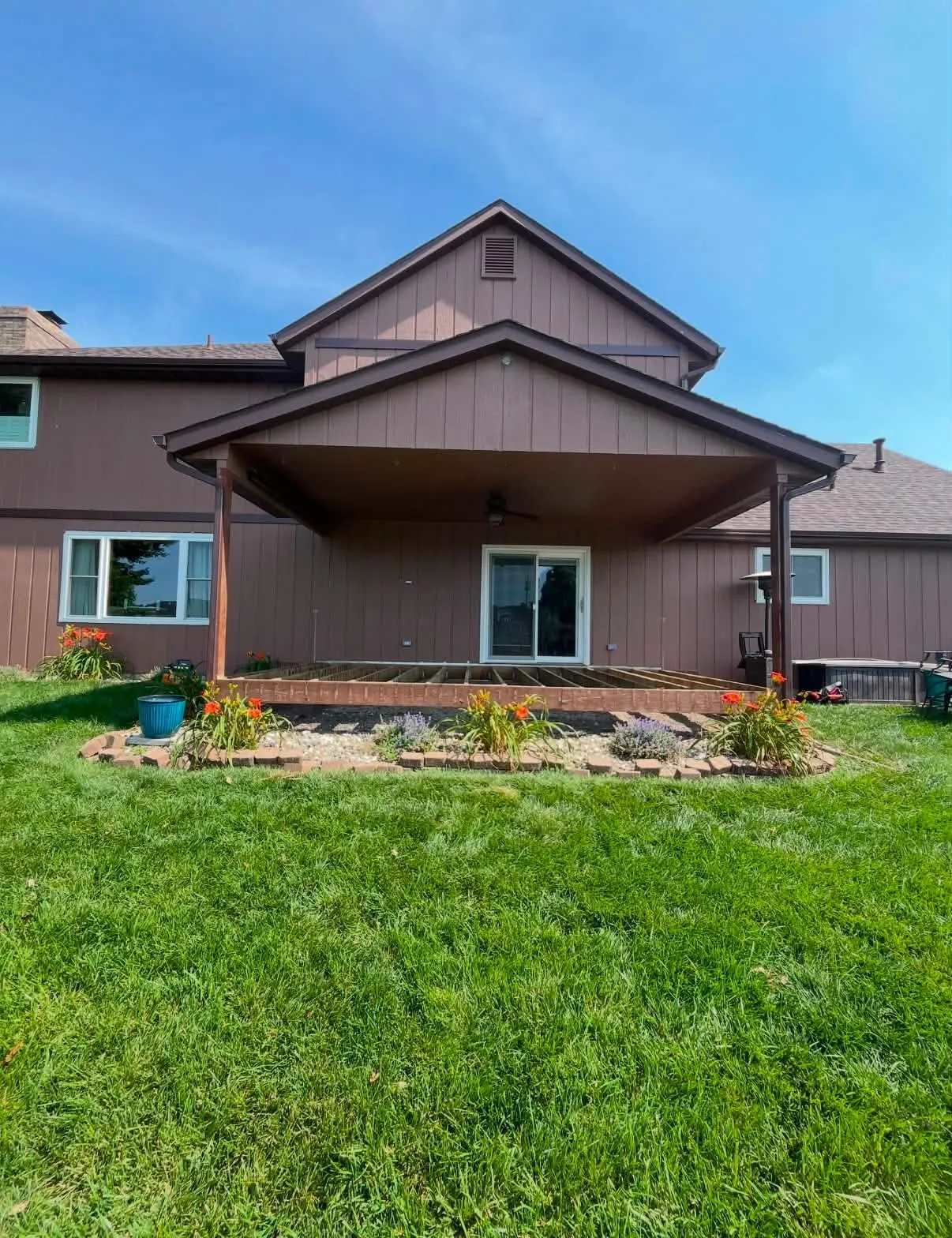 Completed brown home exterior with refreshed siding, trim, and porch