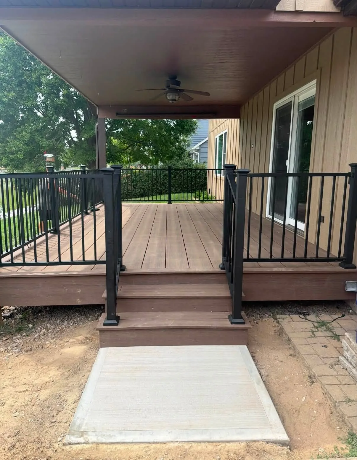 Finished front porch steps with dark railings