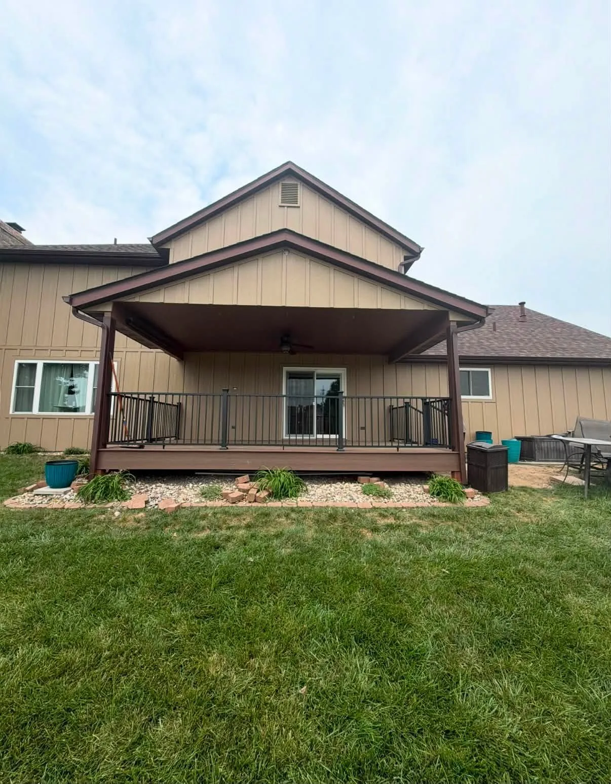 Finished brown home exterior with front porch and steps